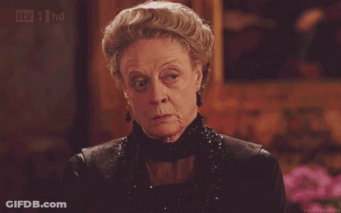 An Older Woman In A Black Dress Is Being Shown On Tv 1 Hd GIF