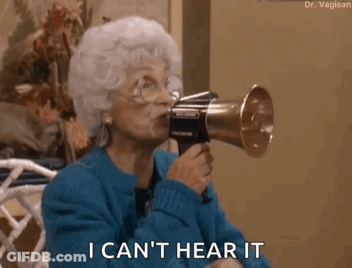 An Older Woman Is Holding A Megaphone In Her Mouth And Says I Can 'T Hear It . GIF