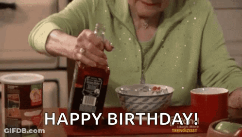 An Older Woman Is Sitting At A Table With A Bowl Of Cereal And A Bottle Of Sauce . GIF