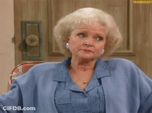 Older Woman Sitting In Chair Wearing Blue GIF