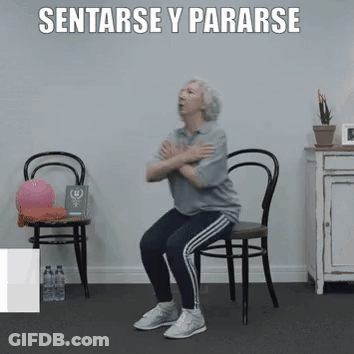An Older Woman Is Squatting On A Chair With Her Arms Crossed . GIF
