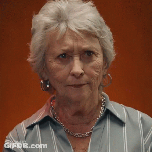 Older Woman In Striped Shirt And Necklace GIF
