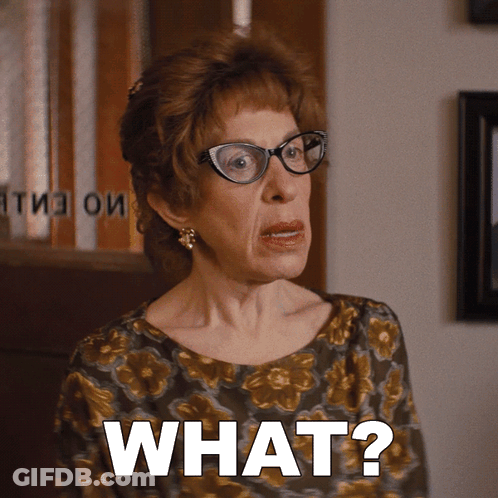 An Older Woman Wearing Glasses Says What GIF