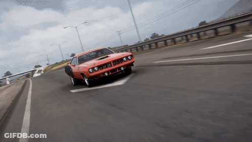 An Orange Car Is Driving Down A Highway With A White Arrow Pointing To The Left GIF