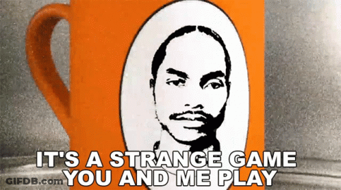 An Orange Coffee Mug With A Picture Of A Man And The Words It 'S A Strange Game You And Me Play GIF