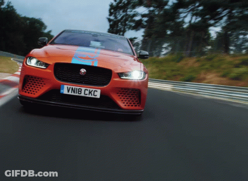 An Orange Sports Car With The License Plate Vni8 Ckc GIF