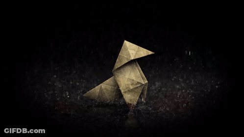 An Origami Bird With A Bloody Beak Is Sitting On A Dark Surface GIF