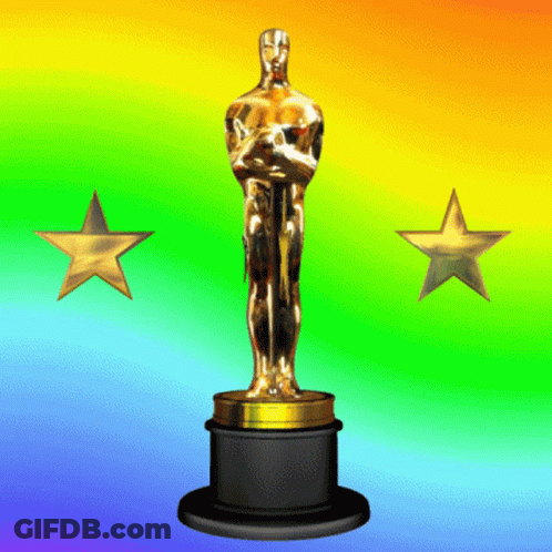 An Oscar Statue Stands In Front Of A Colorful Background GIF