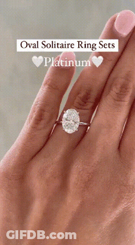 An Oval Solitaire Ring Set In Platinum Is On A Woman 'S Finger GIF