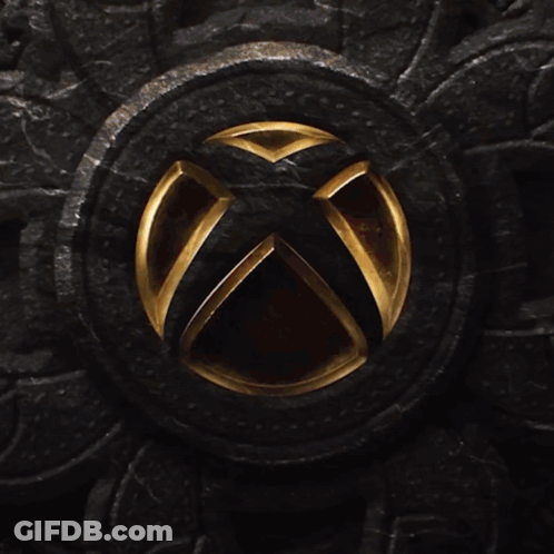 An Xbox Logo Is Lit Up On A Dark Surface GIF