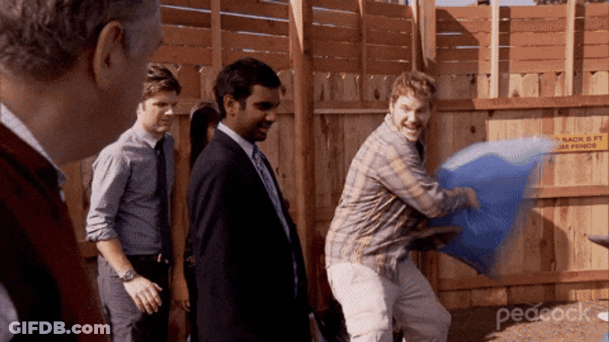 Andy Dwyer Hitting A Man With Stuffed Sack GIF