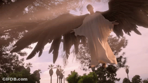 Angel Statue Flying Over City GIF