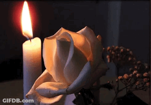 Angel Statue Next To Red Heart With Candle GIF