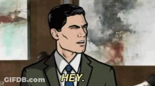 Archer From Archer Is Wearing A Suit And Tie And Says Hey . GIF