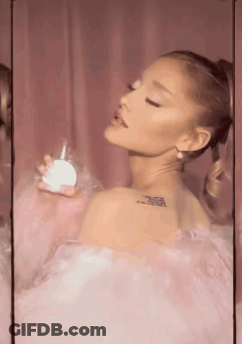 Ariana Grande Holding Perfume Bottle GIF