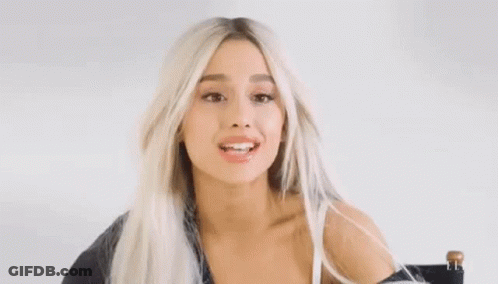 Ariana Grande In Chair With Windblown Hair And Funny Face GIF