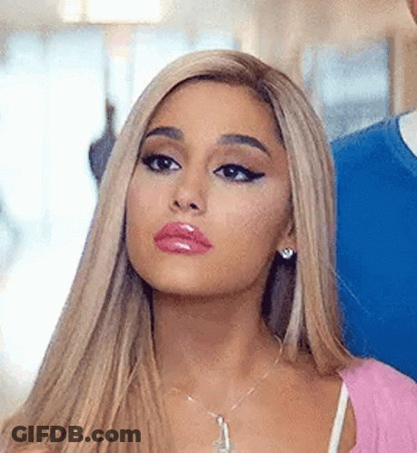 Ariana Grande In Pink Top And Necklace Next To Man GIF