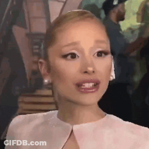 Ariana Grande In White Dress And Earrings Making Face GIF