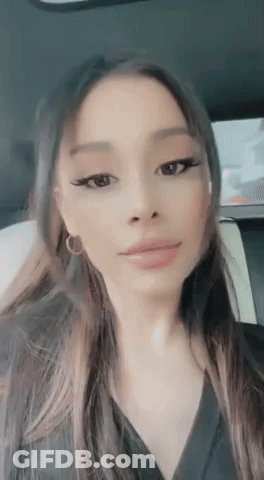 Ariana Grande Is Sitting In The Back Seat Of A Car And Taking A Selfie . GIF