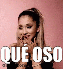 Ariana Grande Is Smiling And Covering Her Mouth With Her Hands While Wearing A Black Top . GIF