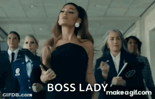 Ariana Grande Is Wearing A Black Dress And Standing In A Hallway With Other Women . GIF