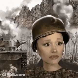 Ariana Grande Is Wearing A Military Helmet In Front Of A Tank . GIF