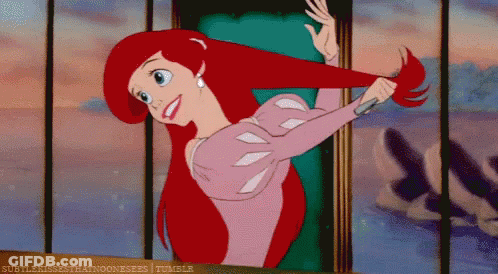Ariel From The Little Mermaid Is Brushing Her Hair With A Comb GIF