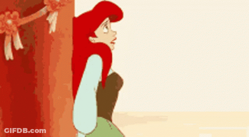 Ariel From The Little Mermaid Is Peeking Out From Behind A Tree GIF