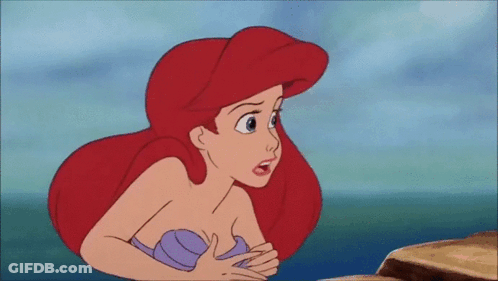 Ariel From The Little Mermaid Is Sitting On A Rock In The Ocean Looking At Something . GIF