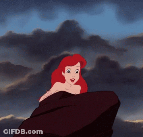 Ariel From The Little Mermaid Is Sitting On A Rock Looking At The Sky . GIF