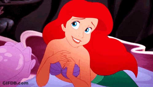 Ariel From The Little Mermaid Is Smiling And Looking At The Camera GIF