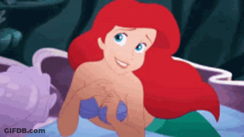 Ariel From The Little Mermaid Is Smiling While Swimming In The Ocean GIF