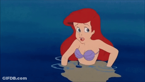 Ariel From The Little Mermaid Is Swimming In The Ocean Next To A Yellow Fish GIF
