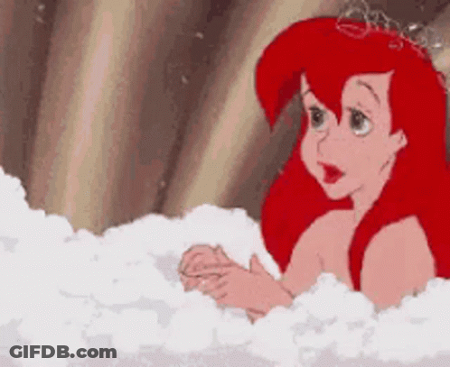 Ariel From The Little Mermaid Is Taking A Bath In A Bathtub Filled With Bubbles . GIF
