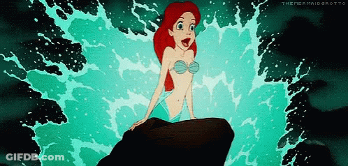 Ariel From The Little Mermaid Sitting On A Rock In The Ocean GIF