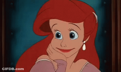 Ariel Smiling Hand On Chin At Window GIF
