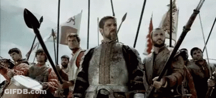 Armored Man Before Men With Spears And Flags GIF