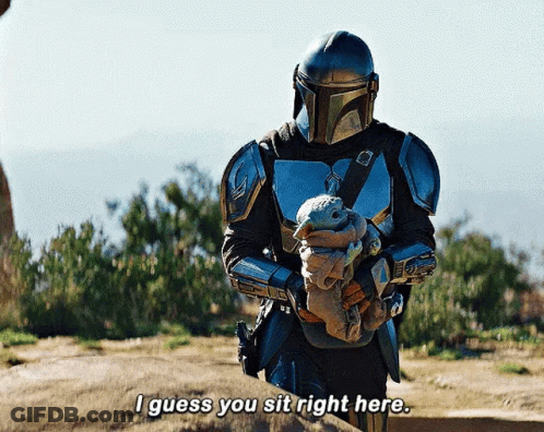 Armored Man Holding Baby Says I Guess You Sit Right Here GIF