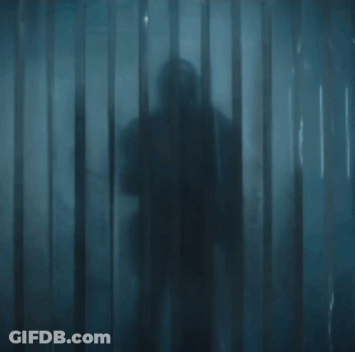 Armored Man Holding Sword In Doorway GIF