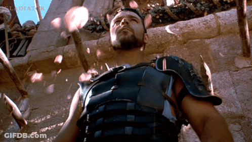 Armored Man In Front Of Wall With Word Gladiator GIF