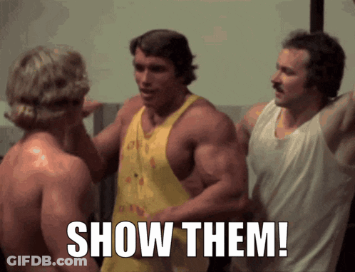 Arnold Schwarzenegger Between Two Shirtless Men Saying Show Them GIF
