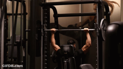 Arnold Schwarzenegger Flexing Muscles Looking At Camera GIF