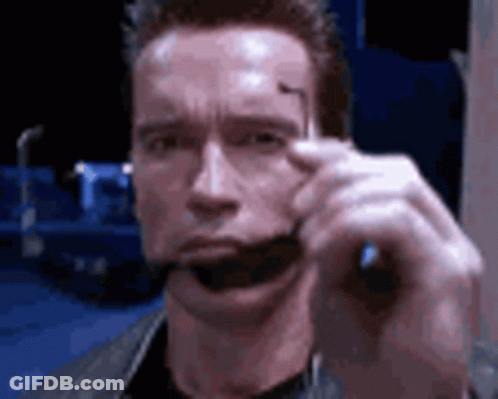 Arnold Schwarzenegger Holding Sunglasses In Mouth GIF