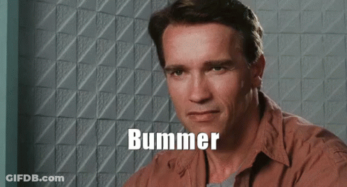 Arnold Schwarzenegger Is Sitting In Front Of A Wall With The Word Bummer Written On It GIF