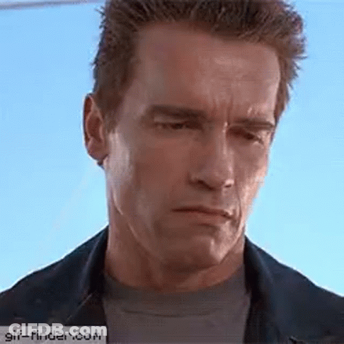Arnold Schwarzenegger Is Wearing A Denim Jacket And A Black Shirt And Making A Funny Face . GIF