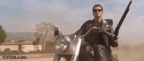 Arnold Schwarzenegger Riding Motorcycle With Shotgun GIF