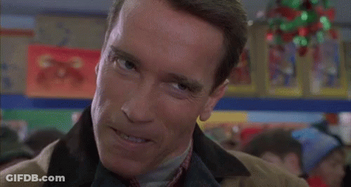 Arnold Schwarzenegger Smiling In Suit And Tie GIF