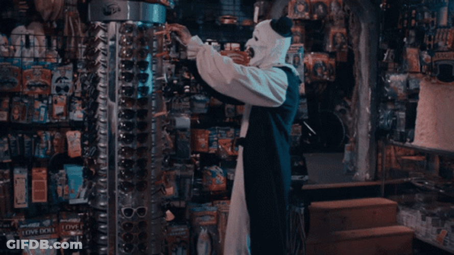 Art The Clown Takes Eyeglass From Display GIF