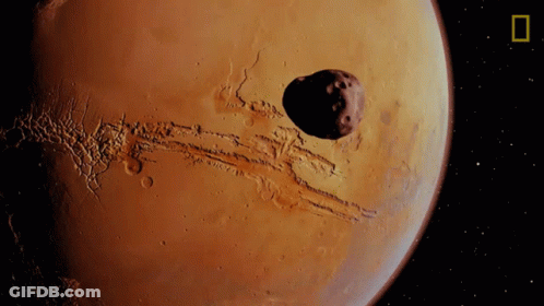 Artist's Impression Of Mars With Large Asteroid GIF
