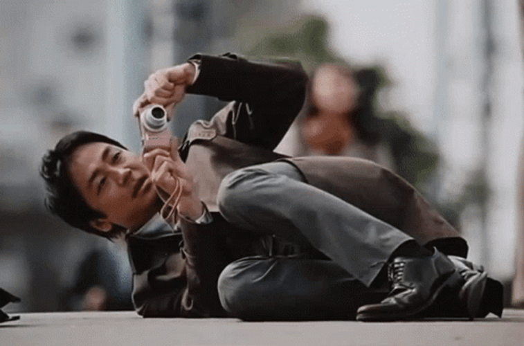 Asian Guy Taking Picture Lying Down GIF